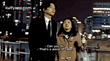 a man in a suit and tie is standing next to a woman in a coat .