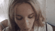a close up of a woman giving a blowjob with her eyes closed