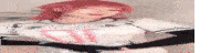 a blurry picture of a woman with red hair wearing a white shirt with a pink letter d on it .