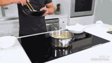 a man is cooking on a stove with the words made in animatica on the bottom right