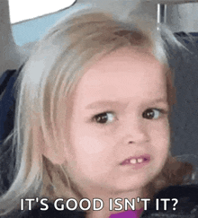 a little girl is making a funny face while sitting in a car .