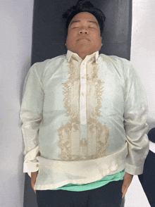 a man laying on a bed with his eyes closed