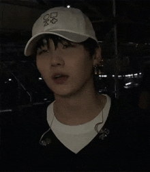 a man wearing a white baseball cap with the letters o and k on it