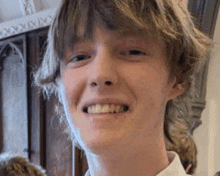 a close up of a young man smiling for the camera .