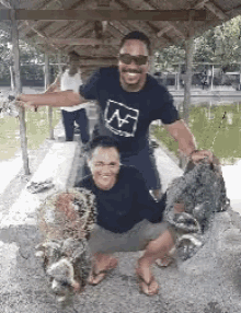 a man and a woman are posing for a picture with fishing nets .