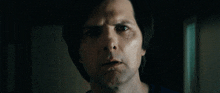 a close up of a man 's face with his eyes closed