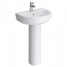a white pedestal sink with a faucet on it