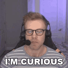 a man wearing headphones and glasses says i 'm curious .