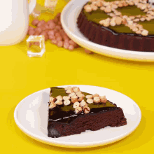 a white plate topped with a slice of chocolate cake