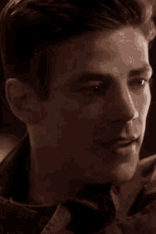 a close up of a man 's face with his eyes closed and smiling .