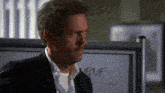 a man in a suit is standing in front of a white board that says " move "
