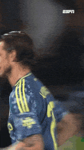 a soccer player wearing a blue and yellow jersey with the number 9 on it