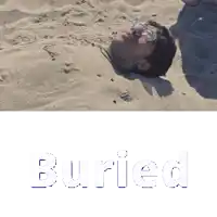 a man is buried in the sand and the word buried is visible