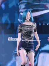 a girl with blue hair is wearing a camo top and shorts