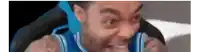 a man in a blue and white basketball jersey is making a funny face .