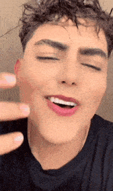 a close up of a young man 's face with his eyes closed