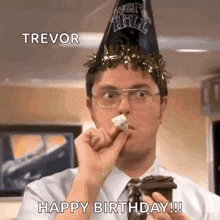 a man wearing a party hat is eating a piece of cake while holding a cup of coffee .