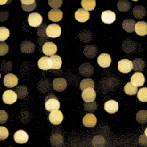 a bunch of yellow lights are hanging from a string