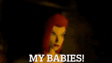 a doll with red hair says my babies in front of her