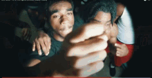 a group of people are standing around a man 's face