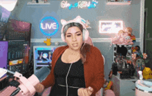 a woman wearing pink headphones is dancing in front of a live sign