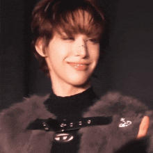 a close up of a person wearing a fur coat and a black turtleneck