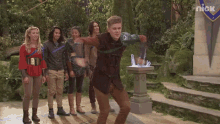a group of people are standing in front of a building that says nick