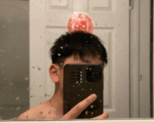 a man taking a picture of himself in the mirror