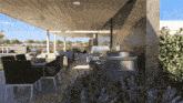 a patio with a table and chairs and a stainless steel grill