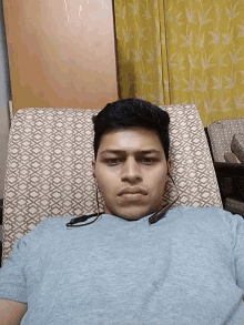 a man wearing headphones laying on a couch