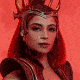 a woman with red hair is wearing a helmet with horns on it .