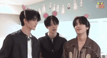 three young men wearing bunny ears are standing next to each other and talking .