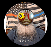 a man with a beard is wearing a we stand shirt