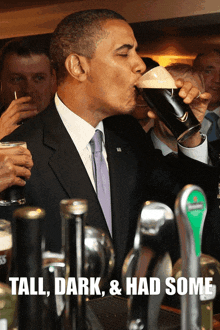 a man in a suit and tie drinking from a glass with the words tall dark and had some below him