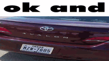 a red avalon with a texas license plate that reads mzw-7605