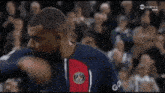 a man in a nike jersey stands in front of a crowd on tnt sports 2