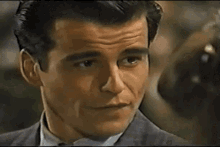 a close up of a woman 's face looking at a man .