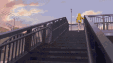 a person in a yellow hoodie is walking down a set of stairs
