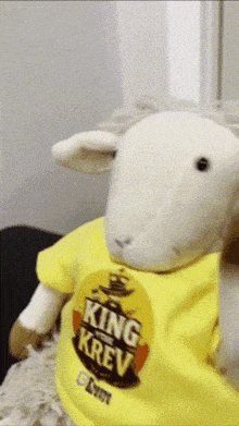 a stuffed animal wearing a yellow shirt that says king krav