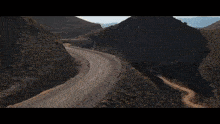 a car is driving down a desert road