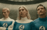 a man and a woman are standing next to each other in a room wearing superhero costumes with the number four on them