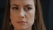 a close up of a woman 's face with long hair