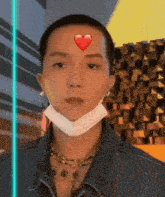 a man wearing a face mask has a heart on his forehead .