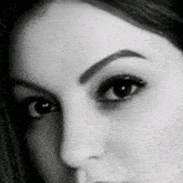 a black and white photo of a woman 's eye