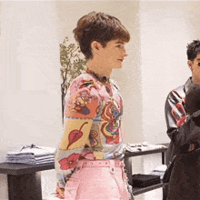 a man in a colorful shirt and pink pants
