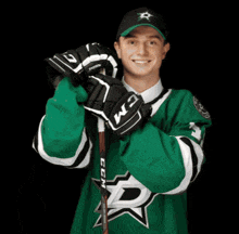 a hockey player wearing a green jersey with the letter d on the front