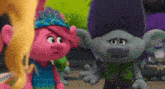 two trolls are talking to each other and one has a crown on her head