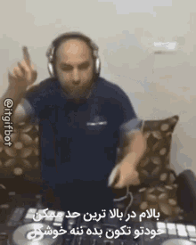 a man wearing headphones is standing in front of a dj mixer and dancing .