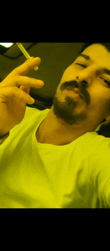 a man with a beard and mustache smoking a cigarette