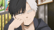 a man with half black and half white hair looks angry